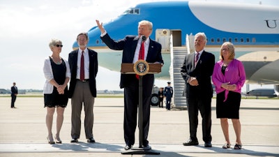 President Donald Trump, accompanied by Michael and Tammy Kushman, left, and Robert and Sarah Stoll, right, speaks in front of Air Force One, Tuesday, June 13, 2017, at General Mitchell International Airport in Milwaukee, Wis.