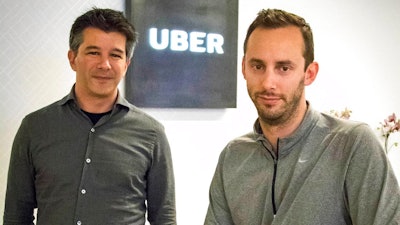 In this Thursday, Aug. 18, 2016, file photo, then-Uber CEO Travis Kalanick, left, and Anthony Levandowski, co-founder of Otto, pose for a photo in the lobby of Uber headquarters, in San Francisco. In a court filing on Thursday, June 22, 2017, Uber said it hired Levandowski, a former Google engineer now accused of stealing trade secrets, even though the company knew at the time that he had information that didn't belong to him. Uber hired Levandowski in August 2016 to head Uber's project on self-driving cars, something he worked on at Google. Uber is asserting that Kalanick told Levandowski not to bring the material with him and that Levandowski assured the company that he had destroyed the five discs containing Google information. Uber recently fired Levandowski.