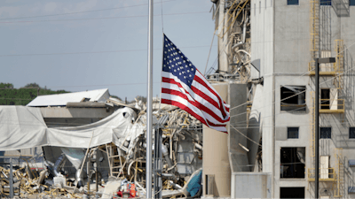 An American flag flies at half-staff in front of the Didion Ethanol Plant in the Village of Cambria, Wis., Friday, June 2, 2017. An explosion at the next-door Didion Milling Plant, background, on Wednesday night killed three employees and injured about a dozen others.