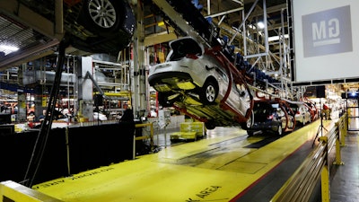 In this Monday, Jan. 28, 2013, file photo, cars move along an assembly line at the General Motors Fairfax plant in Kansas City, Kan. General Motors is extending the normal two-week summer shutdown at two U.S. car factories because of slumping demand. Union officials say the Lordstown, Ohio, plant near Cleveland and the Fairfax plant in Kansas City, Kan., will close for as long as five weeks in June and July 2017.