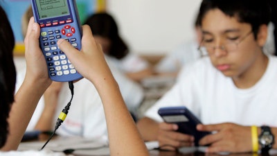 Graphing calculators – like the ones used in this seventh grade Dallas classroom – have become ubiquitous in U.S. education.