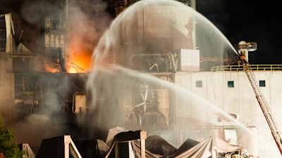 In this photo provided by Jeff Lange, firefighters work at the scene following an explosion and fire at the Didion Milling plant in Cambria, Wis., Thursday, June 1, 2017. Recovery crews searched a mountain of debris on Thursday following a fatal explosion late Wednesday at the corn mill plant, which injured about a dozen people and leveled parts of the sprawling facility in southern Wisconsin, authorities said.