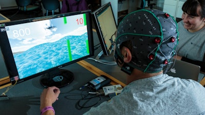 A subject plays a computer game as part of a neural security experiment at the University of Washington.
