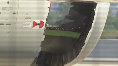 In this image made from video, a hole is seen in the engine of China Eastern airlines Flight 736 after it landed in Sydney, Australia, Monday, June 12, 2017. China Eastern said the crew on Flight 736 noticed damage to the air inlet on the left engine after takeoff Sunday evening and the captain decided to return.