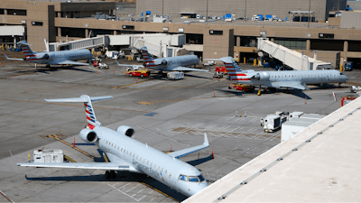 At Phoenix Sky Harbor International Airport American Airlines regional jets sit on the tarmac as American Airlines says seven regional flights have been delayed and 43 have been canceled because of a heat wave as temperatures climb to near-record highs Tuesday, June 20, 2017, in Phoenix.
