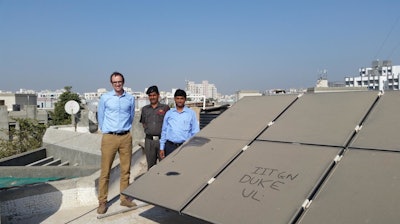 Duke engineering professor Michael Bergin (left) stands with Indian Institute of Technology-Gandhinagar colleague Chinmay Ghoroi (right) next to that university's extremely dusty solar panel array.