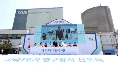 South Korean President Moon Jae-in, center, attends a ceremony marking the shutdown of the country's oldest nuclear power plant, Kori 1, in Busan, South Korea, Monday, June 19, 2017. Moon said Monday that South Korea will move away from the nuclear energy and will not seek to extend the life of existing nuclear plants. The sign reads ' A ceremony marking the shutdown of the Kori 1.'