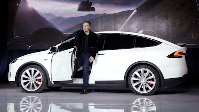 In this Sept. 29, 2015, file photo, Elon Musk, CEO of Tesla Motors Inc., introduces the Model X car at the company's headquarters in Fremont, Calif. Tesla and General Motors have a budding rivalry that could help determine whether Detroit or Silicon Valley sets the course for the future of the auto industry. Right now Wall Street is favoring the upstart led by flamboyant Elon Musk to the established icon headed by the more restrained Mary Barra.
