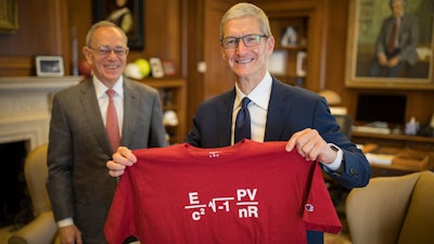 Apple CEO Tim Cook holds up a T-shirt given to him by MIT President L. Rafael Reif in his office before the commencement exercises at the Massachusetts Institute of Technology Friday, June 9, 2017, in Cambridge, Mass.