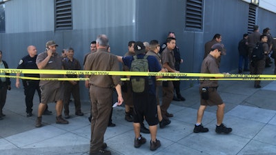 UPS workers gather outside after a reported shooting at a UPS warehouse and customer service center in San Francisco on Wednesday, June 14, 2017. San Francisco police confirmed a shooting at the facility in the Potrero Hill neighborhood but didn’t release information on injuries or the shooter.