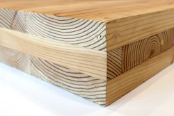 This Nov. 15, 2016, file photo shows a piece of cross-laminated timber, or CLT , in Portland, Ore. City officials in Portland have approved a construction permit for the first all-wood high-rise building in the nation. The building uses the new technology called cross-laminated timber that tests have shown can withstand the worst earthquakes. Developers worked with scientists at Portland State University and Oregon State University to prove through testing that the materials meet all building and fire safety codes.