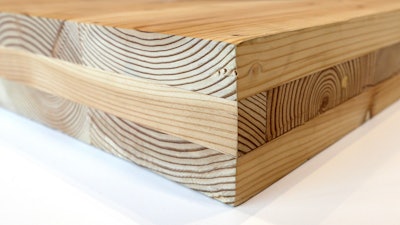 This Nov. 15, 2016, file photo shows a piece of cross-laminated timber, or CLT , in Portland, Ore. City officials in Portland have approved a construction permit for the first all-wood high-rise building in the nation. The building uses the new technology called cross-laminated timber that tests have shown can withstand the worst earthquakes. Developers worked with scientists at Portland State University and Oregon State University to prove through testing that the materials meet all building and fire safety codes.