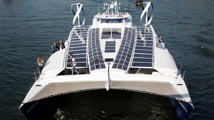 In this Tuesday, July 4, 2017 file photo, the Energy Observer, a former race boat turned into a autonomous navigation with hydrogen, sails on the Seine river in Paris. A boat that fuels itself is setting off from Paris Saturday, July 15, 2017, on a six-year round-the-world journey that its designers hope serves as a model for emissions-free energy networks of the future.
