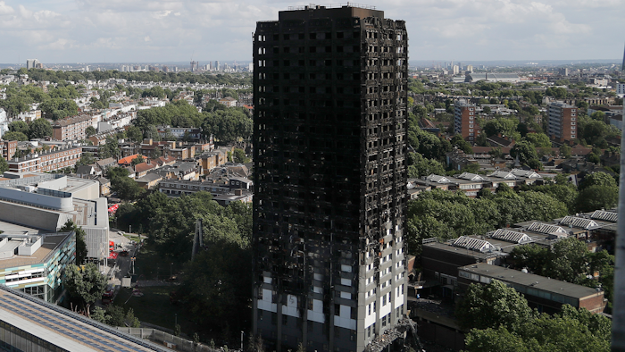 This is a Thursday, June 15, 2017 file photo of The scorched facade of the Grenfell Tower in London after a massive fire raced through the 24-storey high-rise apartment building in west London. British police have described the painstaking work of recovering remains from a burnt-out London high-rise, four weeks after the disaster killed at least 80 people. The Metropolitan Police force says it will take months to identify all the victims, and the agonizing wait has provoked anger and dismay from victim's families.