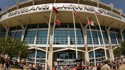 In this Sunday, Sept. 13, 2009 file photo, fans walk into Cleveland Browns Stadium before the Minnesota Vikings play the Cleveland Browns in an NFL football game, in Cleveland. In sales brochures, a U.S. company boasted of the 'stunning visual effect' its shimmering aluminum panels created in an NFL stadium, an Alaskan school and a 33-story hotel on Baltimore's waterfront.