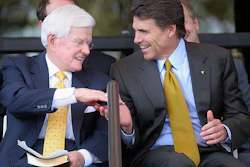 In this Sept. 18, 2005, photo, Lonnie 'Bo' Pilgrim, CEO and Chairman of the Board of Board of Pilgrim's Pride Chicken, left, shakes hands with Texas Gov. Rick Perry at the Dedication Open House of the companies new headquarters in Pittsburg, Texas. Pilgrim, who grew a one-time feed store into the world's largest poultry producer before losing the company in bankruptcy, has died at 89. A statement on the Erman Smith Funeral Home website says Pilgrim died Friday, July 21, 2017, at his Pittsburg home.