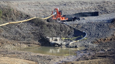 In this Thursday, Jan. 14, 2016, photo, a drainage pipe that was the original culprit of the coal ash spill is shown at the Dan River Steam Station in Eden, N.C. Duke Energy Corp. is digging up and hauling away from riverbanks the toxic coal residues two years after one of the worst coal-ash spills in U.S. history. The nation’s largest electric company now wants regulators in North Carolina to force consumers to pay nearly $200 million a year to clean up the toxic byproducts of burning coal to generate power. The request filed with state utility regulators in June 2017 is the first time Duke Energy Corp. has sought permission to have North Carolina consumers pay part of its costs of cleaning up the waste, which are estimated to total $5.1 billion in North and South Carolina alone.