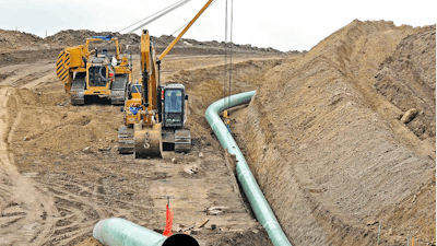 In this Oct. 5, 2016, file photo, heavy equipment works at a site where sections of the Dakota Access pipeline are being buried near the town of St. Anthony in Morton County, N.D. The Army Corps of Engineers says additional environmental review of the already-operating pipeline ordered by a judge in June 2017 is likely to take the rest of the year.