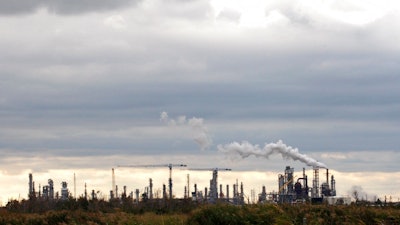 IN this Dec. 2, 2009, file photo, the Total Port Arthur refinery is shown in Port Arthur, Texas. Federal lawsuits against the U.S. Environmental Protection Agency were filed claiming the agency has failed to correct Texas air pollution control permits with loopholes that make state enforcement rare. The suits filed Thursday, July 20, 2017, by the nonprofit Washington, D.C.-based Environmental Integrity Project, target permits for the largest integrated petrochemical factory in the U.S., three refineries near the Houston Ship Channel including the largest petroleum refinery in the U.S. and a coal-fired power plant east of Dallas.
