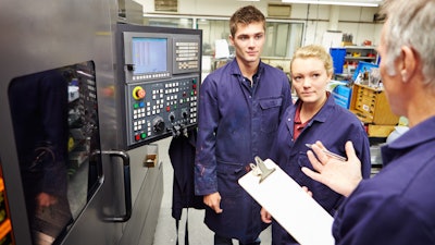 Engineer Teaching Apprentices To Use Computerized Lathe 458860281 2122x1415