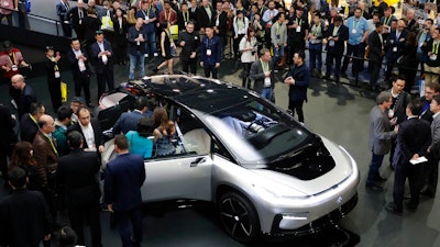 In this Jan. 3, 2017, file photo, Faraday Future's FF 91 electric car is unveiled during a news conference at CES International in Las Vegas. Electric car maker Faraday Future said Monday, July 10, 2017 that it is deserting its plan to construct a $1 billion manufacturing plant in southern Nevada eight months after suspending the project and sinking at least $120 million into it.