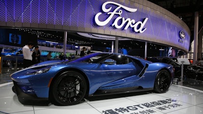 In this Wednesday, April 19, 2017, file photo, a sports car is displayed at the Ford stand during the Auto Shanghai 2017 show at the National Exhibition and Convention Center in Shanghai, China. The Ford Motor Co. reports earnings, Wednesday, July 26, 2017.