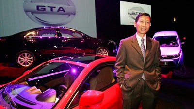 In this Oct. 6, 2009 file photo, Xiaolin 'Charles' Wang, president and chief executive officer of GreenTech Automotive Inc., speaks to reporters near three prototype cars his startup company hoped to build in Tunica, Miss. Mississippi's state auditor Stacey Pickering said Wednesday, July 5, 2017, that the leader of the troubled electric car maker and the company, should repay $6.36 million in state and local aid the company received, plus what Pickering says are penalties, interest and recovery costs. GreenTech promised to invest $60 million and create 350 jobs in Robinsonville.
