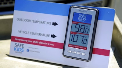 In this July 30, 2015 file photo, St. Mary's and Safe Kids Coalition uses a wireless monitor to record the temperature outside and inside of a closed vehicle at St. Mary's Market Days in Evansville, Ind. A proposed new law that would require carmakers to build alarms for backseats is being pushed by child advocates who say it will prevent kids from dying in hot cars and also streamline the criminal process against caregivers who cause the deaths, cases that can be inconsistent but often heavier-handed against mothers. The latest deaths came in Arizona on triple-digit degree days over the last weekend of July 2017.