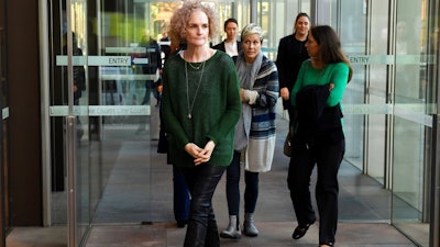 Members of the class action against Johnson & Johnson, Gai Thompson, left, Joanne Maninon, center, and Carina Anderson, right, arrive to address the media outside the Federal Court in Sydney on Tuesday, July 4, 2017. More than 700 Australian women have joined a class-action lawsuit against Johnson & Johnson over the pharmaceutical giant's vaginal mesh implants.