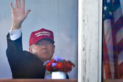 President Donald Trump waves to spectators as he watches the third round of the U.S. Women's Open Golf tournament from his observation booth, Saturday, July 15, 2017, in Bedminster, N.J.