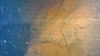 This image captured by an underwater robot provided by International Research Institute for Nuclear Decommissioning shows lava-like lumps believed to contain melted fuel inside the Unit 3 reactor at Fukushima Dai-ichi nuclear plant in Okuma town, northeastern Japan, Friday, July 21, 2017. Plant operator Tokyo Electric Power Co. said the robot found the objects Friday on its second mission inside the primary containment vessel of the Unit 3 reactor at Fukushima, which was destroyed by a massive earthquake and tsunami. Experts believe the fuel melted and much of it fell to the chamber's bottom and is now submerged by radioactive water.