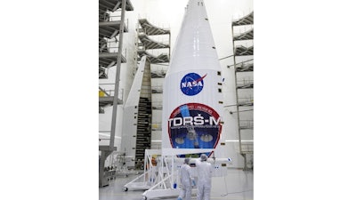 In a July 13, 2017 photo provided by NASA, the payload fairing for NASA's Tracking and Data Relay Satellite, TDRS-M, is inspected prior to encapsulating the spacecraft, inside the Astrotech facility in Titusville, Fla. NASA said Monday, July 17, 2017, that one of the antennas on the Tracking and Data Relay Satellite, was damaged last Friday. The mishap could delay what was supposed to be an Aug. 3 liftoff aboard an Atlas V (five) rocket.