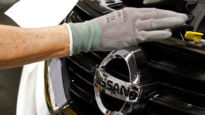 In this April 6, 2016, file photo, a Nissan technician inspects the grill of a new 2016 Altima on the assembly line at the Nissan Canton Vehicle Assembly Plant in Canton, Miss. The United Auto Workers union filed Monday, July 10, 2017, an election petition with the National Labor Relations Board, to force a unionization election at the plant following years-long pressure campaign to build support.