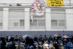 Hundreds of police and security agents with anti-riot gear gather outside the PepsiCo plant on the outskirts of Buenos Aires, Argentina, Thursday, July 13, 2017. Security forces clashed Thursday with former PepsiCo employees after resisting eviction from the plant. Workers had occupied the plant after PepsiCo closed the plant last month for logistical reasons.