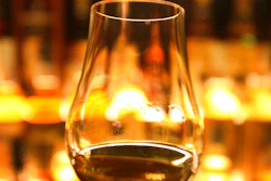 In this March 10, 2013 file photo, a glass of whisky is held up in front of the Diageo Claive Scotch Whisky collection in Edinburgh, Scotland. Scotland has called for Scotch to be defined in U.K. law so that the whisky industry can be protected after Brexit.