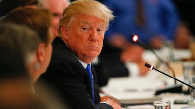 President Donald Trump listens during a 'Made in America,' roundtable event in the East Room of the White House, Wednesday, July 19, 2017, in Washington.