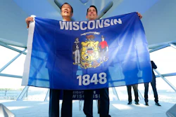 Foxconn Chairman Terry Gou, left, and Gov. Scott Walker hold the Wisconsin flag to celebrate their $10 billion investment to build a display panel plant in Wisconsin, at the Milwaukee Art Museum in Milwaukee, Wis., Thursday, July 27, 2017.