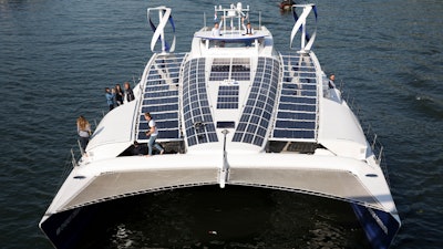 In this Tuesday, July 4, 2017 file photo, the Energy Observer, a former race boat turned into a autonomous navigation with hydrogen, sails on the Seine river in Paris. A boat that fuels itself is setting off from Paris Saturday, July 15, 2017, on a six-year round-the-world journey that its designers hope serves as a model for emissions-free energy networks of the future.