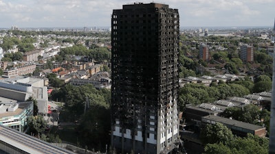 This is a Thursday, June 15, 2017 file photo of The scorched facade of the Grenfell Tower in London after a massive fire raced through the 24-storey high-rise apartment building in west London. British police have described the painstaking work of recovering remains from a burnt-out London high-rise, four weeks after the disaster killed at least 80 people. The Metropolitan Police force says it will take months to identify all the victims, and the agonizing wait has provoked anger and dismay from victim's families.