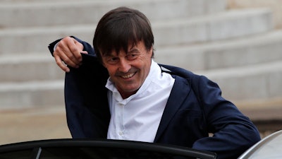 In this May 18, 2017 file photo, Environment Minister Nicolas Hulot arrives for the first weekly cabinet meeting under new French President Emmanuel Macron, at the Elysee Palace in Paris. Hulot unveiled a five-year plan to fight against climate change and fulfill the country's commitments under the Paris accord. Hulot said France will stop producing power from coal-power station by 2022.