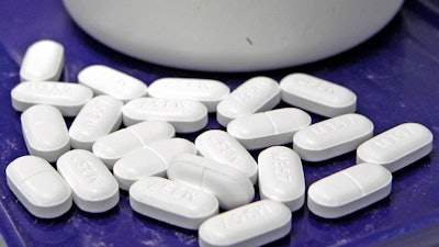 This file photo shows hydrocodone-acetaminophen pills, also known as Vicodin. A government report finds opioid prescription rates have been falling in recent years overall, but rising in more than 1 in 5 U.S. counties.
