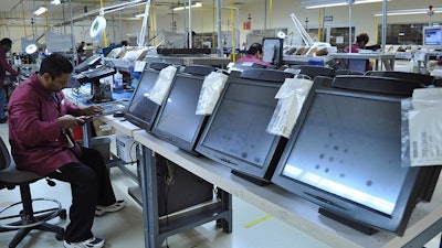 A technician repairs computer monitors at Amcor Service Solutions, a part of Tecma Group, which operates 18 maquiladoras for 33 companies in the Mexican northern border city of Ciudad Juarez, Mexico.