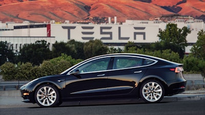 This undated image provided by Tesla Motors shows the Tesla Model 3 sedan. The electric car company’s newest vehicle, the Model 3, which set to go to its first 30 customers Friday, July 28, 2017, is half the cost of previous models. Its $35,000 starting price and 215-mile range could bring hundreds of thousands of customers into Tesla’s fold, taking it from a niche luxury brand to the mainstream.