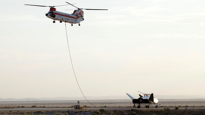 Sierra Nevada Corp's 'Dream Chaser' test spacecraft is prepared to be lifted by a helicopter for a test at Edwards Air Force Base, Calif. on Wednesday, Aug. 30, 2017.
