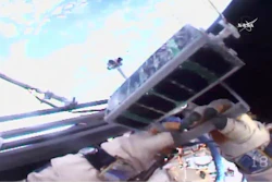 In this image made from video provided by NASA, Russian cosmonaut Sergei Ryazansky holds a mini satellite before launching it by hand from the International Space Station on Thursday, Aug. 17, 2017.
