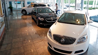 In this Wednesday, April 26, 2017, photo, 2017 Buick automobiles appear on display in the showroom at a GMC Buick dealership in Miami. U.S. sales of new cars and trucks showed another decline in July 2017 as consumers pulled back on purchases and waited for Labor Day deals. July marked the seventh straight month of declines in a peaking market.
