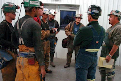 In this Aug. 28, 2009, file photo, coal miners receive a safety briefing at Signal Peak Energy's Bull Mountain coal mine near Roundup, Mont. A judge has blocked a proposed 176-million ton expansion of the mine because federal officials did not consider its climate change impacts.