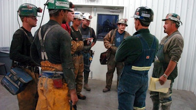 In this Aug. 28, 2009, file photo, coal miners receive a safety briefing at Signal Peak Energy's Bull Mountain coal mine near Roundup, Mont. A judge has blocked a proposed 176-million ton expansion of the mine because federal officials did not consider its climate change impacts.