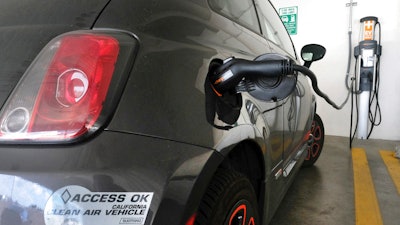 This April 25, 2016, photo shows an electric Fiat plugged into a charging station in a parking lot in Los Angeles. California could spend up to $3 billion under a bill that would widely expand its consumer rebate program for zero-emission vehicles. The Legislature is pushing forward a bill that could lift rebates from $2,500 to $10,000 or more for a compact electric car. Current rebates have done little to boost sales.