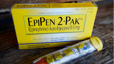 This Oct. 10, 2013, file photo, shows an EpiPen epinephrine auto-injector, a Mylan product, in Hendersonville, Texas. Mylan has finalized a $465 million federal agreement settling allegations it overbilled Medicaid for its emergency allergy injectors for a decade, charges brought after rival Sanofi filed a whistleblower lawsuit and tipped off the government.